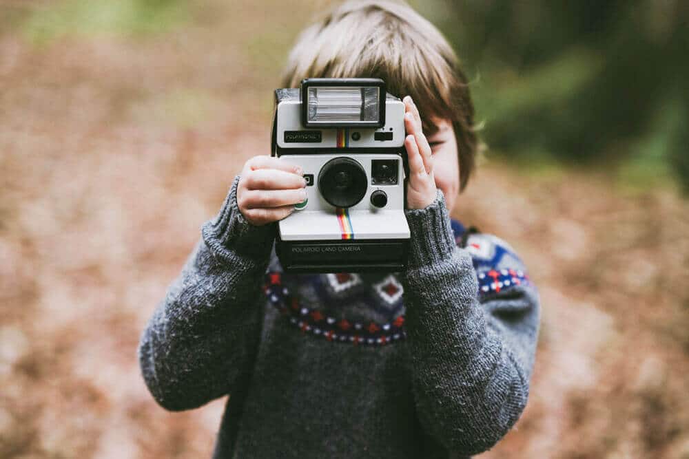 Kid with instant camera digital cameras image.