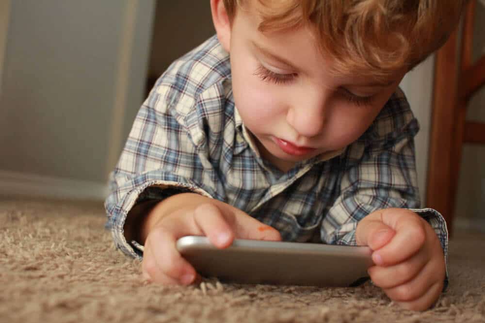 Kid with phone digital cameras image.