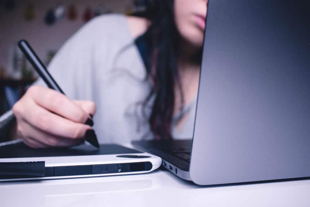 girl editing with stylus on tablet