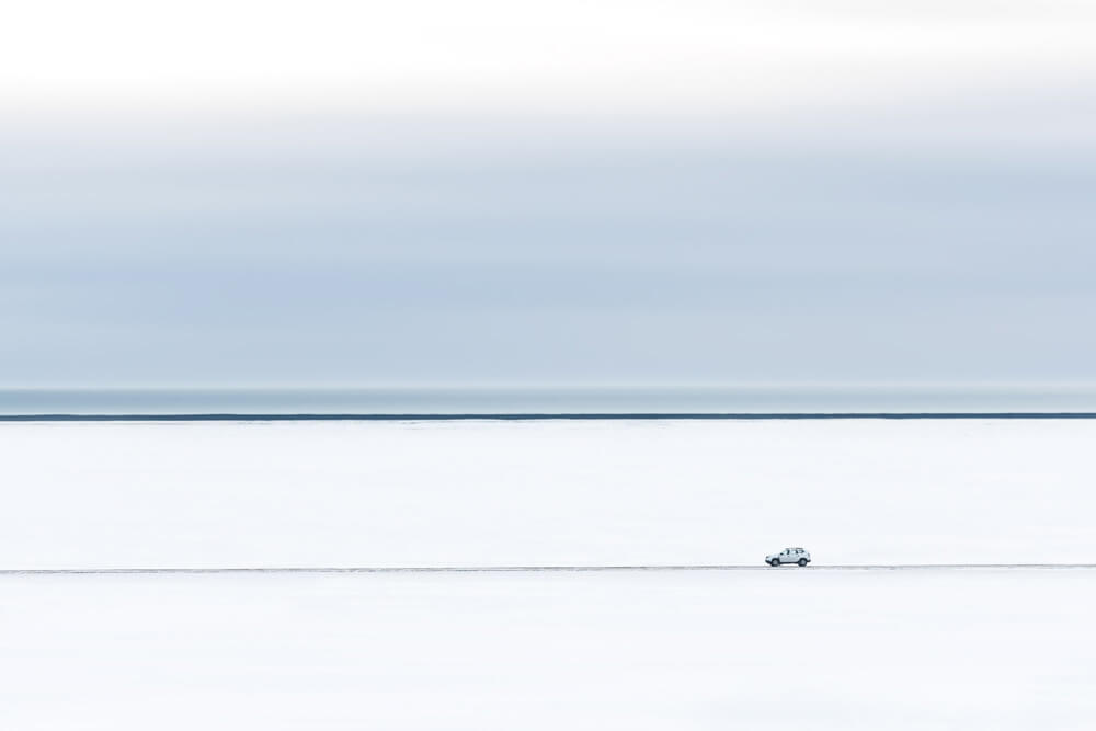 car driving along snowy road