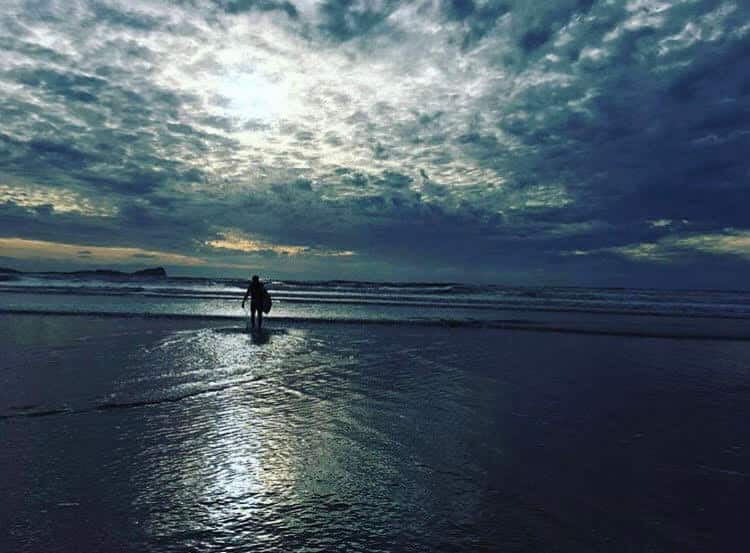 surfer heading out to sea