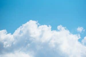 blue sky with white fluffy cloud on bottom half